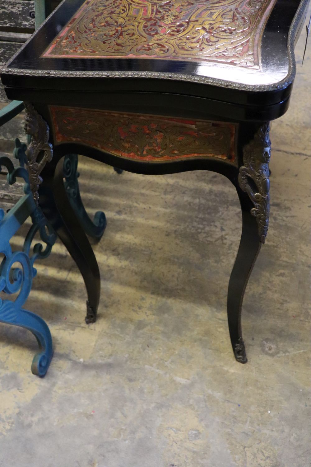 A 19th century French red boullework and ebony card table, with serpentine top, width 74cm